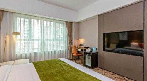 a hotel room with a bed and a large window at New Pearl River Hotel in Guangzhou