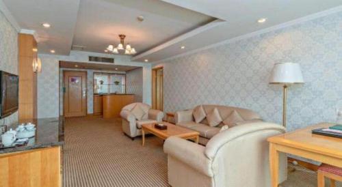 a living room with a couch and a table at New Pearl River Hotel in Guangzhou