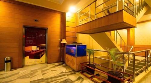 a lobby with a television in a building at Garuda Hotel Pontianak in Pontianak
