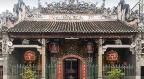 an ornate building with a red door and a gate at Rain Bow Hotel in Ho Chi Minh City
