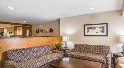 a living room with two couches and a table at Quality Inn & Suites in Mount Juliet