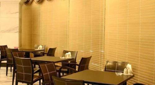 a row of tables and chairs in a restaurant at Metro Tourist Hotel Cheonan in Cheonan