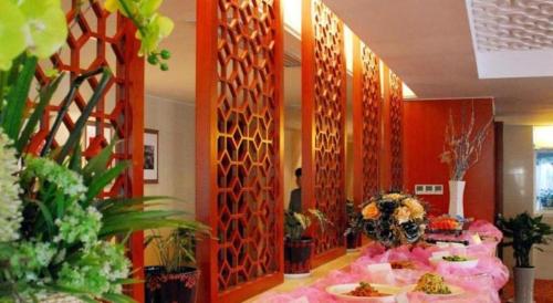 a room with a table with food on it at Xian Qujiang Yinzuo Hotel in Xi'an