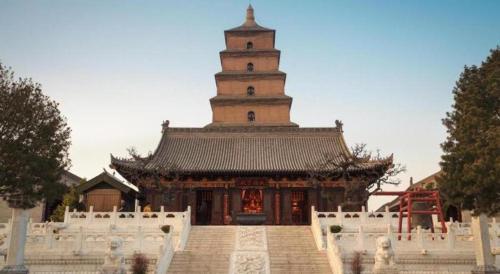 a large building with a tower in the background at Xian Qujiang Yinzuo Hotel in Xi'an