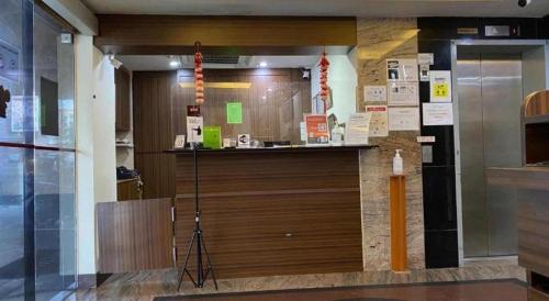 a lobby with a large wooden counter in a building at Darlene Hotel in Singapore