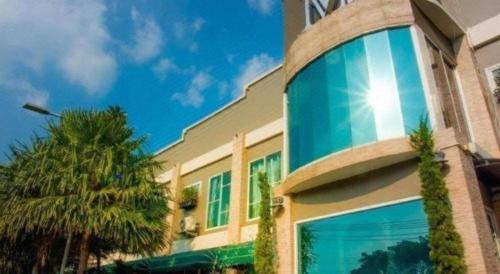 a building with a large window on the side of it at The Loom Rangsit in Pathum Thani