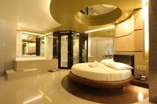 a bedroom with a large bed with a large mirror at One Serenata Hotel General Trias in Silang