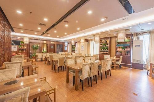 a dining room with wooden tables and chairs at Yanji Yanbian International Hotel in Yanji