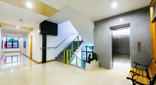 a hallway with a staircase in a house at GT Residence Hotel in Buriram