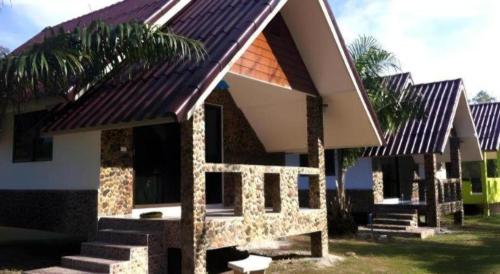 a small house with stairs and a roof at Ma-Kham Forest Resort in Nakhon Nayok