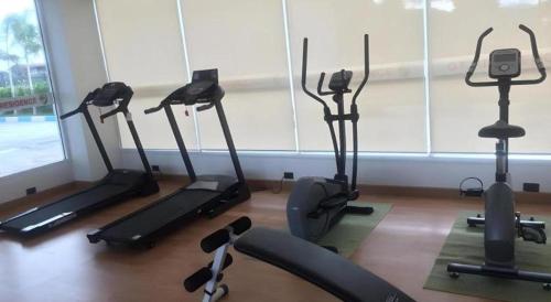 a gym with several exercise bikes in a room at GT Residence Hotel in Buriram