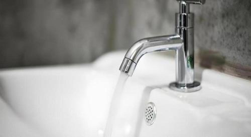 a sink with a faucet in a bathroom at Ma-Kham Forest Resort in Nakhon Nayok