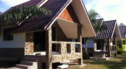 a small house with some stairs in front of it at Ma-Kham Forest Resort in Nakhon Nayok