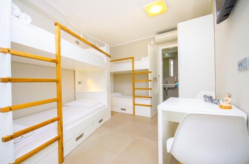 a small room with bunk beds and a desk at Hostel Dvor in Split