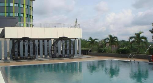 a swimming pool in front of a building at CK Tanjungpinang Hotel and Convention Centre in Tanjung Pinang 