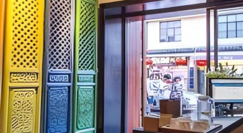 a window of a store with different colored glass at Dali Four Seasons Hostel in Dali Ancient Town