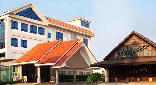 a building with an orange roof on the side of it at NH Elegant Hotel in Sakon Nakhon