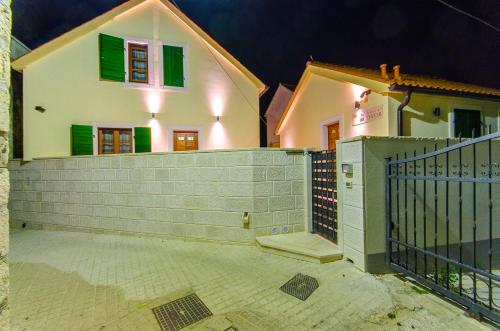 a house with a fence in front of it at Hostel Dvor in Split