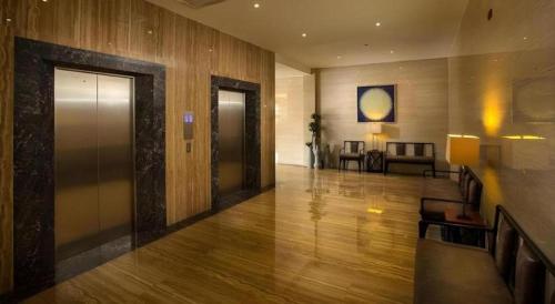 a lobby of a hotel with a door and a couch at Lotus Blu Hotel in Legazpi