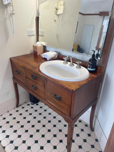 a bathroom with a sink and a mirror at Wandering Trout - Gourmet Stays in Mole Creek