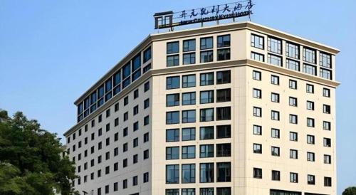 a tall building with a sign on top of it at New Century Kylie Hotel Ningbo in Ningbo