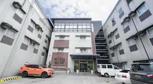 an orange car parked in front of a building at Eighty Eight Hotel in Koronadal