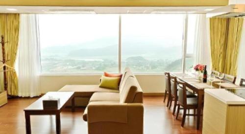 a living room with a couch and a table at Mungyeong saejae Resort in Mungyeong