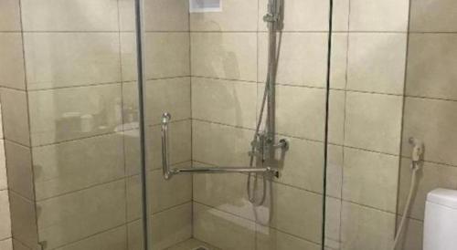 a shower with a glass door in a bathroom at Bacninh Charming Hotel in Bắc Ninh