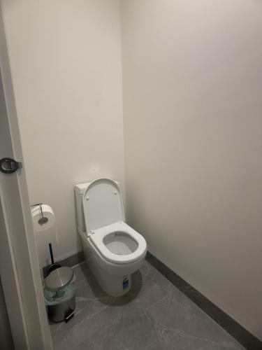 a bathroom with a toilet in a white room at Peaceful Private Room in Wyndham Vale in Wyndham Vale