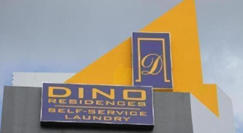 a sign for a dino laundry istg at Dino Residences in Dumaguete
