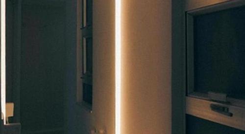 a light on the side of a wall in a room at SLEEEP HKG Causeway Bay in Hong Kong