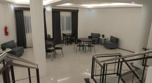 a room with chairs and tables in a building at Fiesole Residence Inn in Dumaguete
