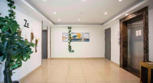 an empty hallway with a plant in a room at GreenTree Inn Shanghai National Convention and Exhibition Center Huaxiang Road in Shanghai