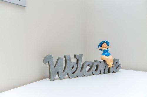 a figurine sitting on top of the word mitzoria at Hostel Dvor in Split