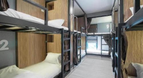 a group of bunk beds in a room at OYO 726 Sookjai Cafe and Hostel in Chiang Mai