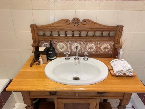 a sink on a wooden counter in a bathroom at Wandering Trout - Gourmet Stays in Mole Creek
