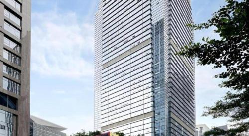 a tall building with a lot of windows at Golden Central Hotel Shenzhen in Shenzhen