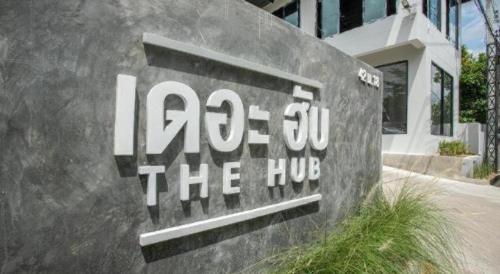 a sign in front of a building at The Hub Hotel Surin in Surin