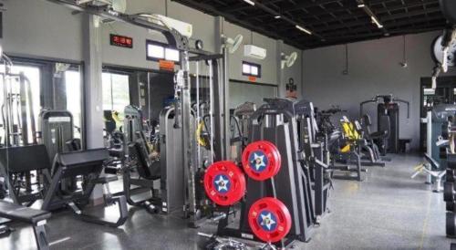 a gym with a bunch of bikes and machines at The Hub Hotel Surin in Surin