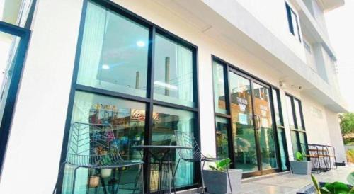 a building with large glass windows on the side of it at The Hub Hotel Surin in Surin