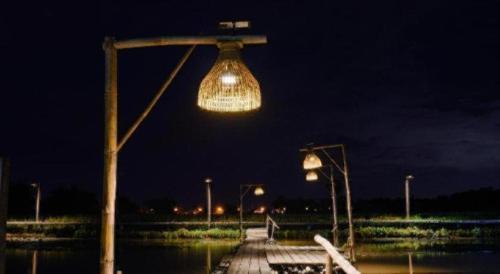 a light hanging over a dock at night at Nornnadubua in Uthai Thani