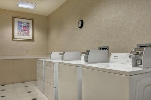 a room with washing machines and a clock on the wall at Hilton Garden Inn Oshkosh in Oshkosh