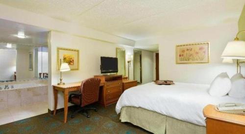 a hotel room with a bed and a desk and a television at Hampton Inn Mt. Vernon in Webster Hill Estates