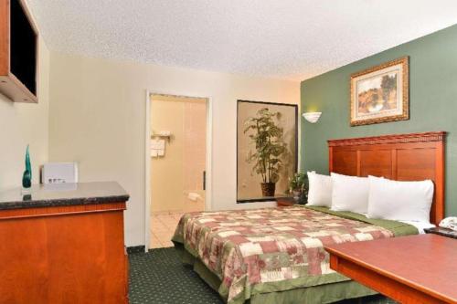 a hotel room with a bed and a desk at Americas Best Value Inn Redlands San Bernardino in Redlands