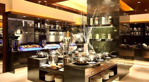 a kitchen with many pots and pans on a counter at Kunshan Newport Hotel in Suzhou