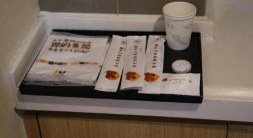 a table with some donuts and a cup of coffee at IU Hotel Chengdu High-Tech Zone Longhu Times Street in Chengdu