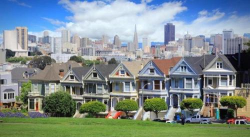 a row of houses with a city in the background at The Annex - Hayes Valley in San Francisco