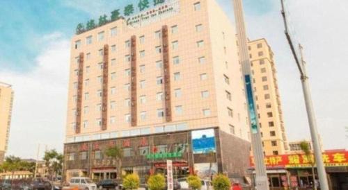 a large building in the middle of a city at GreenTree Inn Jinzhong PinGYAo City South Railway Station Express Hotel in Pingyao