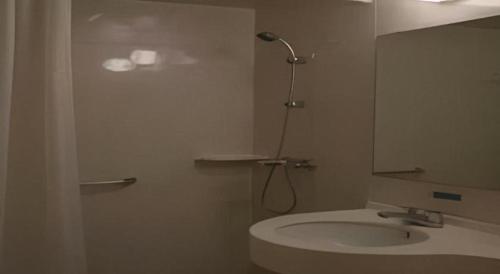 a bathroom with a sink and a shower and a mirror at Jinjiang Inn Wenzhou Shuangyu The Terminal in Wenzhou