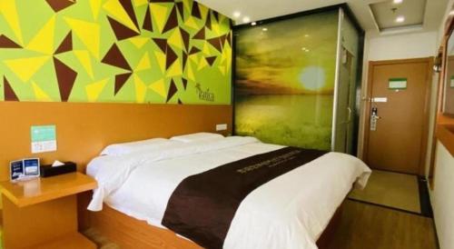 a bedroom with a large bed and a colorful wall at Vatica Beijing Tongzhou Liyuan Universal Studios in Beijing